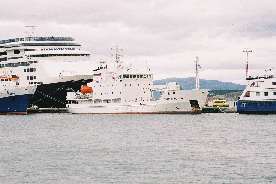 The Grigoriy Mikheev dwarfed by the Amsterdam